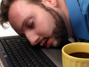 bigstockphoto_Man_Asleep_On_Laptop_With_Cup__5671