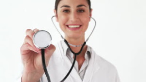 stock-footage-smiling-doctor-showing-her-stethoscope-against-a-white-background